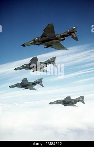 An air-to-air left underside view of four 37th Tactical Fighter Wing F-4E Phantom II aircraft in formation during the Tactical Air Command bombing and gunnery competition Gunsmoke '85. Subject Operation/Series: GUNSMOKE '85 State: California (CA) Country: United States Of America (USA) Stock Photo