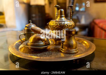 Making coffee according to an old Arabic recipe. metal copper objects for making coffee on the table Stock Photo