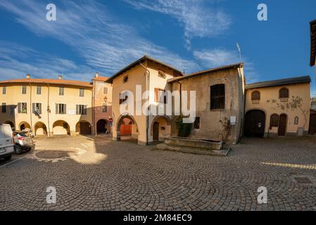 Peveragno, Cuneo, Italy - January 09, 2023: Piazza Carboneri with the nursery school in the historic building which formerly houses the town hall with Stock Photo