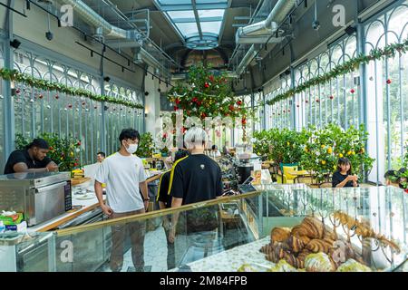 Kuala Lumpur, Malaysia - December 11th, 2022 - People having breakfast  at cafe 'Lemon Tree' Stock Photo