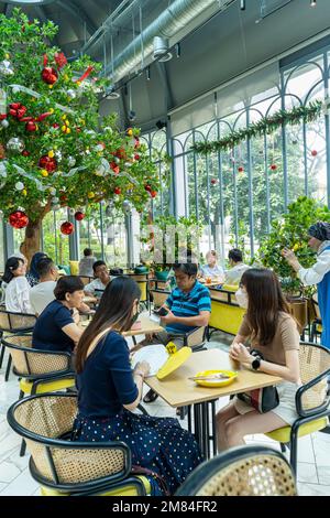 Kuala Lumpur, Malaysia - December 11th, 2022 - People having breakfast  at cafe 'Lemon Tree' Stock Photo