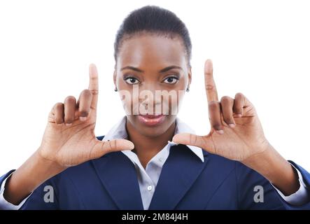 Picture this. Studio shot of a young businesswoman framing her face with her fingers. Stock Photo