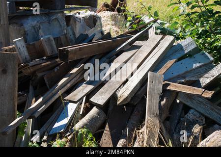 Background from scraps of old boards and planks before they are sawn with nails Stock Photo