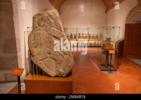 A pre-Hispanic Danzante stone figure from Monte Alban. Museum of Oaxacan Culture, Oaxaca, Mexico.  Originally thought to be dancing figures, they are Stock Photo