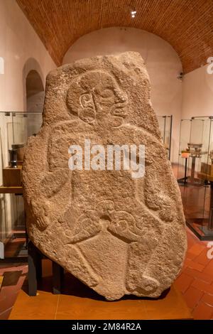 A pre-Hispanic Danzante stone figure from Monte Alban. Museum of Oaxacan Culture, Oaxaca, Mexico.  Originally thought to be dancing figures, they are Stock Photo