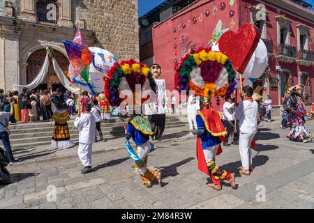 Danza la Pluma dancers perform for a wedding party in front of the Sangre de Cristo Church in Oaxaca, Mexico. Stock Photo