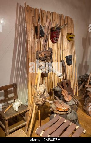 Masks and musical instruments from various eras in Oaxaca In the Museum of Oaxacan Cultures in Oaxaca, Mexico. Stock Photo
