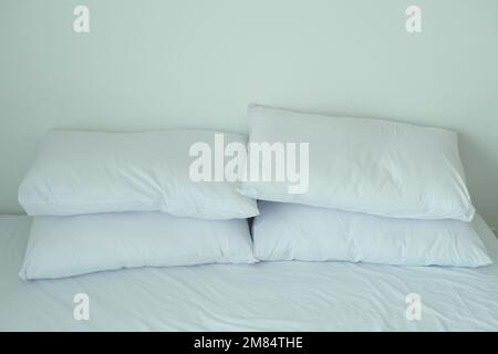 white pillow lined up on bed  Stock Photo