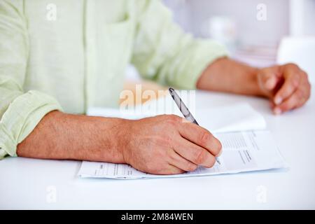 Please sign here. a businessman signing contracts. Stock Photo
