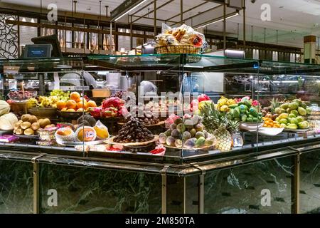 London, UK - 5th January 2023: Food Court of Harrods, one the most famous shops in the world, showing a display of fresh tropical, exotic fruits. Foun Stock Photo