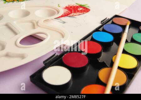 Colorful paints, brush, palette and a picture of fruits in perspective view. Leisure activity and hobby. Toned image template Stock Photo
