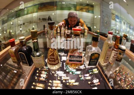 Nordhausen, Germany. 12th Jan, 2023. Miniature bottles stand on a glass display case in the traditional Nordhausen distillery. For four weeks, around 800 bottles will be on display in the exhibition 'From Mini to Maxi - Germany's Smallest and Largest Bottles'. The bottles come from the collection of around 3,000 bottles of the Eckes company, to which Nordbrand Nordhausen belonged from 1991 to 2007, and from the collection of a collector from Pößneck. Credit: Matthias Bein/dpa/Alamy Live News Stock Photo