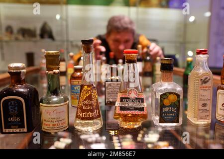 Nordhausen, Germany. 12th Jan, 2023. Miniature bottles stand on a glass display case in the traditional Nordhausen distillery. For four weeks, around 800 bottles will be on display in the exhibition 'From Mini to Maxi - Germany's Smallest and Largest Bottles'. The bottles come from the collection of around 3,000 bottles of the Eckes company, to which Nordbrand Nordhausen belonged from 1991 to 2007, and from the collection of a collector from Pößneck. Credit: Matthias Bein/dpa/Alamy Live News Stock Photo