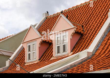 WILLEMSTAD, CURACAO - NOVEMBER 22, 2007: Two pink dormers on a tiled roof in the historical Alley District in Otrobanda, Willemstad, Curacao. Stock Photo