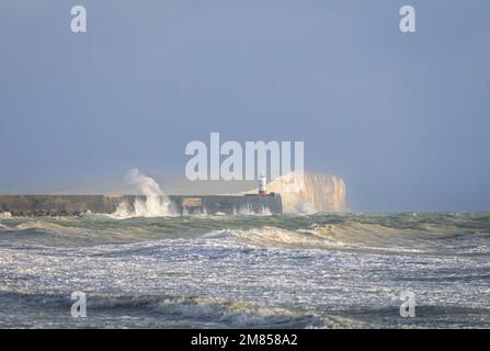 Strong winds and crashing waves at Newhaven lighthouse on the east Sussex coast south east England Stock Photo
