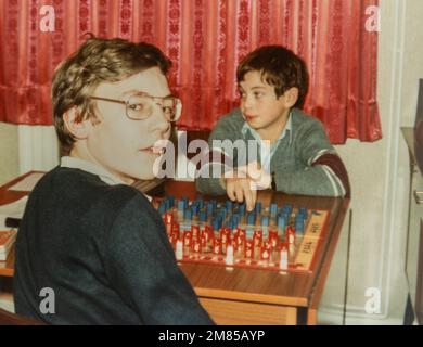 Two boys children kids playing Guess Who board game, archival photo from around 1982, England, UK Stock Photo