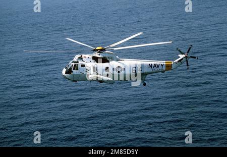 A left side view of an SH-3H Sea King helicopter from Helicopter Anti-submarine Squadron 17 (HS-17) in-flight. Country: Mediterranean Sea (MED) Stock Photo