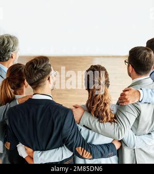 business teamwork together support group colleague businessman businesswoman team office strong colleague holding hug Stock Photo