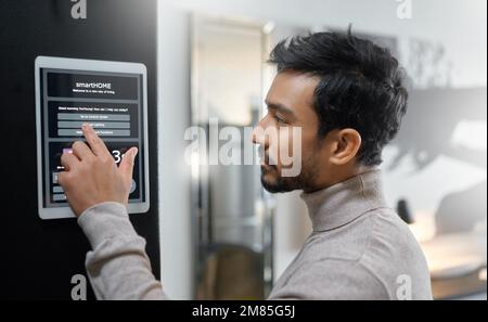 Smart home wall system, technology and man with digital screen interface for room lighting, house automation or air conditioning. AI software app Stock Photo