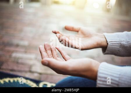 Hands, praying and religion with a man muslim prayer to God in faith or devotion in islamic worship during eid or ramadan. Islam, trust or mosque with Stock Photo