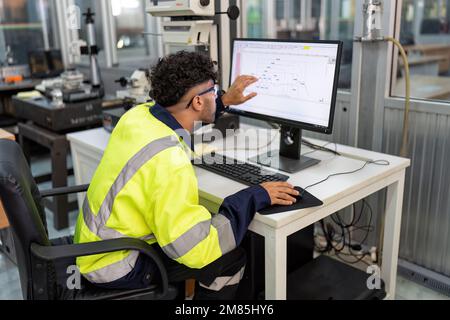 Engineer sitting in robot electronic room use computer create process analogue and logic diagram Stock Photo