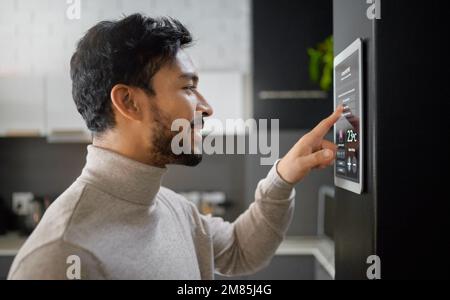 Smart home technology, wall system and man with digital ui monitor for thermostat heating, safety security network or air conditioning. AI software Stock Photo