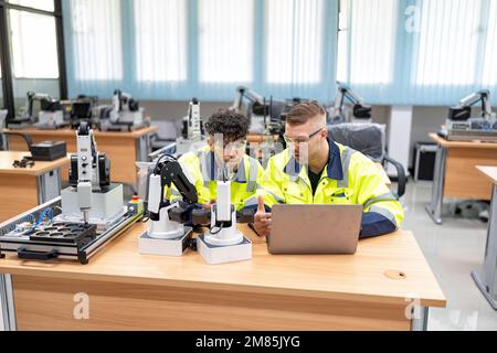 Engineer learn basic theory how to operation maintenance and programing robot arm in training room Stock Photo