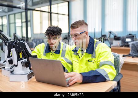 Engineer learn basic theory how to operation maintenance and programing robot arm in training room Stock Photo