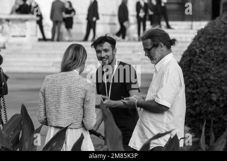 A TV crew from Servus TV preparing to go on air for a news broadcast about Vladimir Putin's visit to Vienna June 2018, some dignitaries in background Stock Photo