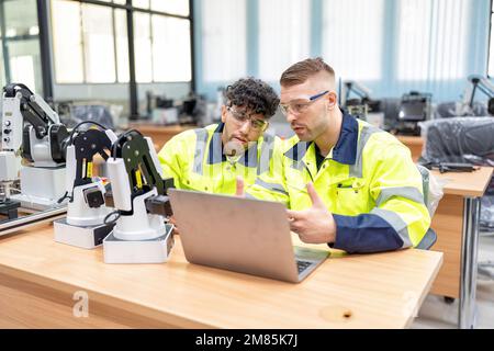 Engineer learn basic theory how to operation maintenance and programing robot arm in training room Stock Photo