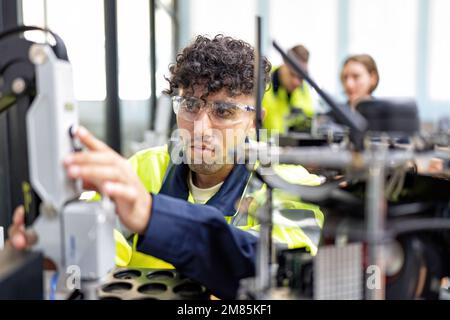 Engineer learn basic theory how to operation maintenance and programing robot arm in training room Stock Photo