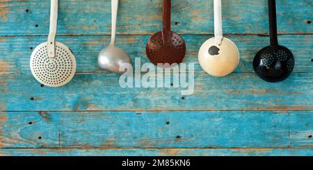 various professional vintage kitchen utensils on rustic wooden wall, food and drink, gastronomy business concept, free copy space Stock Photo
