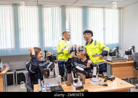 Engineer celebrate success examination passed on maintenance and programing robot in training room Stock Photo