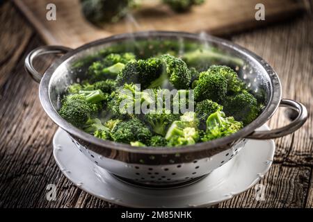 Steamed broccoli in a stainless steel steamer. Healthy vegetable concept. Stock Photo