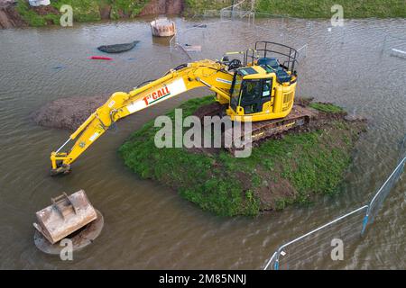 Upton-upon-Severn, Worcestershire, January 12th 2023 - A small Worcestershire town has been flooded after the River Severn burst its banks due to rising water levels. A waste recycling centre has been closed along with a local access road, Hanley Road, which has been closed by the local council. A large yellow digger was also seen marooned on a small grassy mound as the flooding surrounded it. Credit: Katie Stewart/Alamy Live News Stock Photo