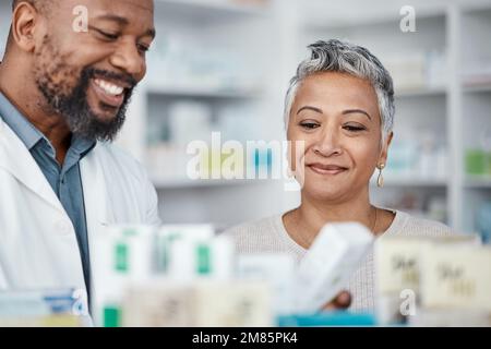 Pharmacy, medicine and senior woman consulting pharmacist on prescription. Healthcare worker, shopping and female in consultation with black man for Stock Photo