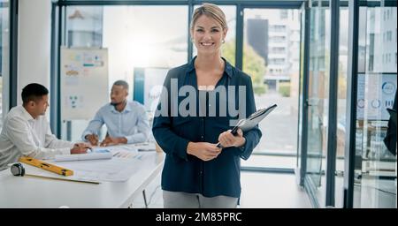 Portrait, documents and building with a woman architect standing in her office boardroom at work. Architecture, design and mindset with a female Stock Photo