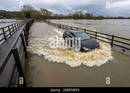A flooded road near the village of Lacock in Wiltshire where the river Avon has burst its banks after heavy rain over night and through today. Stock Photo