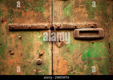 rusty door lock with deadbolt, on weathered wooden door, Valletta, Malta, Europe Stock Photo
