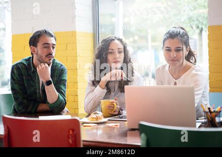 University students team studying together on a new project in creative coworking classroom - Bright filter with focus on woman on center Stock Photo