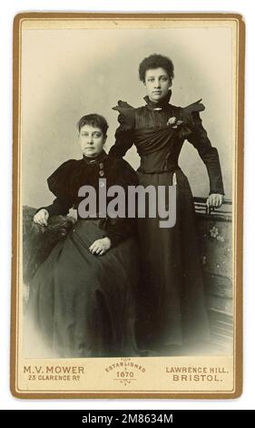 Original CDV (Carte de Visite or visiting card) of a wealthy / middle class mixed race young Victorian woman with her mother. Possibly they are in mourning as the mother looks very sad and wear black.. The young lady dress has winged sleeves typical of 1897 or 1898 and the mother wears puff sleeves that were beginning to reduce in size from the late 1890's. From the studio M. Mower, 23 Clarence road, Lawrence Hill, Bristol, England, U.K. Stock Photo