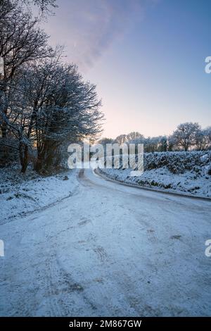 Narrow snow covered rural road near Monmouth in South Wales. Stock Photo