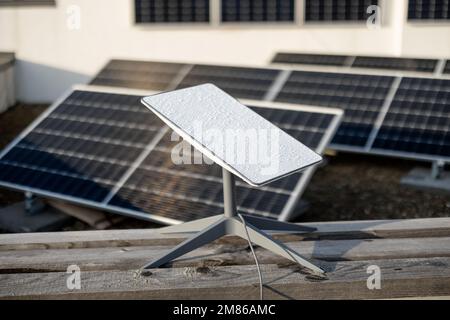 Starlink satellite dish on roof of residential building Stock Photo