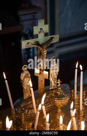 Jesus on the cross and candles inside Bulgarian St. Stephen Church, an orthodox church in Balat, famous for being made of prefabricated cast. Stock Photo