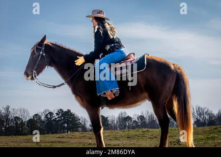 Ft Mill, SC, USA. 11th Jan, 2023. A beautiful brunette cowgirl poses with her horse before riding in the country (Credit Image: © Walter G. Arce Sr./ZUMA Press Wire) EDITORIAL USAGE ONLY! Not for Commercial USAGE! Stock Photo