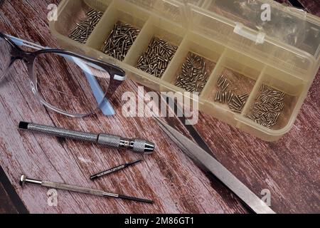 Tool for repairing glasses on a wooden table Stock Photo