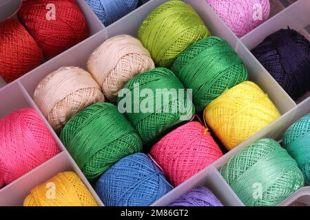 box with spools of colored threads for embroidery Stock Photo