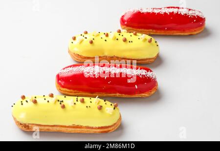 Delicious glazed eclairs isolated on white background Stock Photo