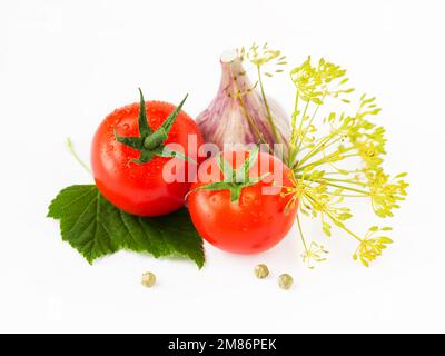 Tomatoes, leaves, garlic clove, dill, peppercorn isolated on white background Stock Photo