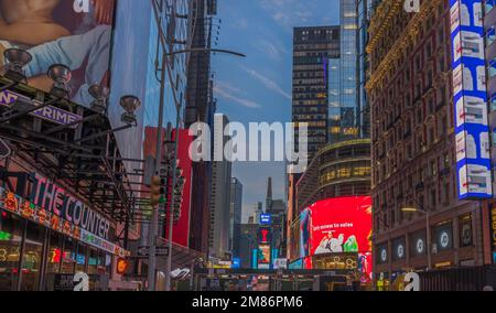 Beautiful view of night Broadway with advertising television screens against background of night sky. New York. USA. Stock Photo